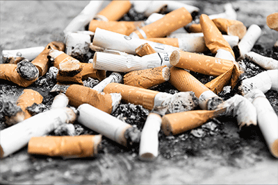 A Pile of Used Cigarettes on the Floor
