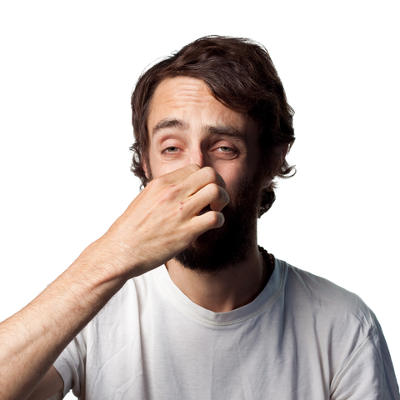 man pinching his nose sensing a bad smell