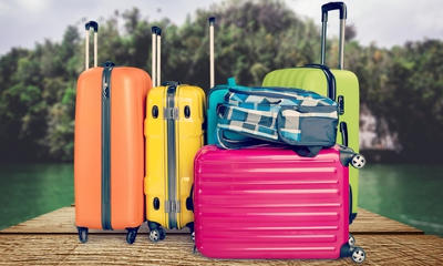 coloured suitcases piled on top of eachother