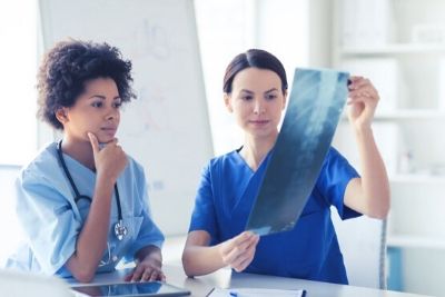 Doctors Looking at X-Ray Scan of the Lungs and Spine