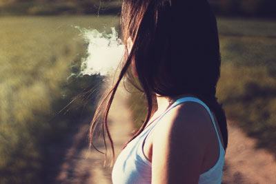 Woman Exhaling Vapour Cloud
