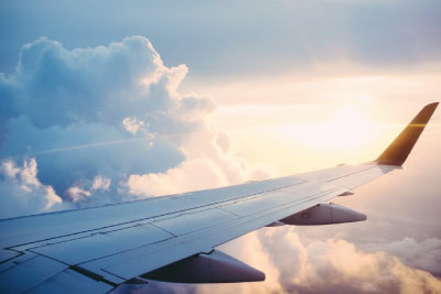 Wing of an Aeroplane Flying Through the Clouds