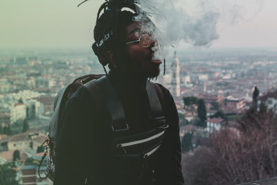 Man Vaping Using Sub Ohm Device Sitting Down