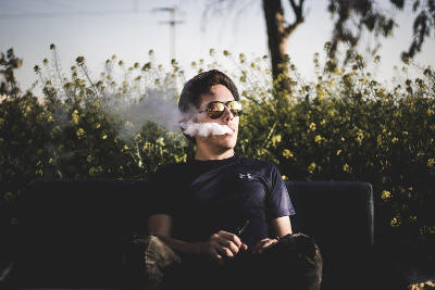 young man sitting and vaping