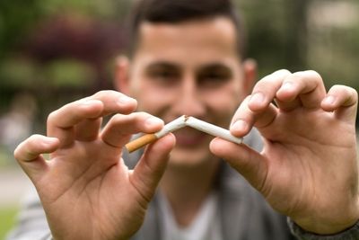 Man Breaking Cigarette in Two for Stoptober