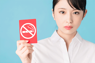 Woman Holding No Smoking Sign