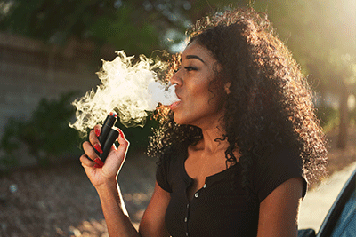 Woman Sub-Ohm Vaping With a Shortfill