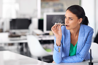 Woman Vaping in the Office