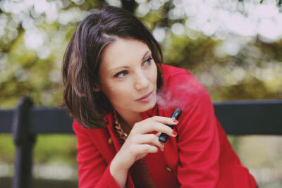 Woman Vaping on a Bench