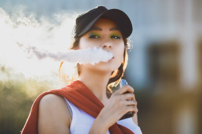 alt="Woman Vaping With High Wattage Vaporiser"